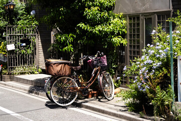 Japanese people travelers riding biking vintage bicycle stop at front of antique retro wooden...