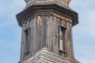 Weathered ancient wooden Orthodox church in a Central European village, under overcast or dim light...