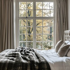 Luxury bedroom with a large window overlooking the autumnal landscape. Mock up with copy space