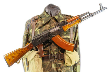 Mannequin in Ukrainian military uniform, camouflage fatigues greens and yellows, jacket, pants, boots, AK-47 rifle, wooden stock, wooden foregrip, metal barrel, empty, safety engaged, neutral backg