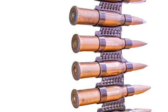 Collection of cylindrical, pointed bullets on metallic strip, varying wear and headstamps visible, aged appearance, no additional context