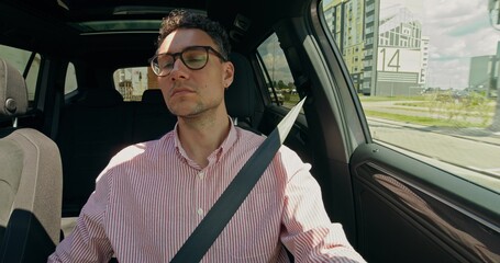 Front view of a stylish man as he driving a car