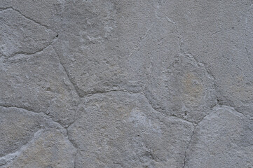 Texture of old rustic wall covered with gray stucco.