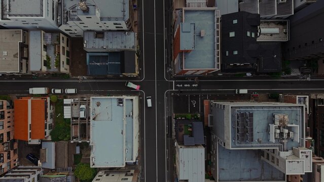 Top view of a street in Tokyo. Roofs of houses and roads from a drone