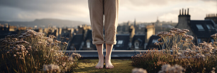 A woman stands on a rooftop garden filled with wildflowers, gazing at the city skyline during the golden hour, blending nature with urban beauty, showcasing serenity and reflection, banner