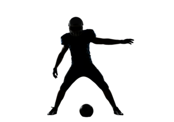Football Player Silhouette Kicking Ball Isolated On A Black Background