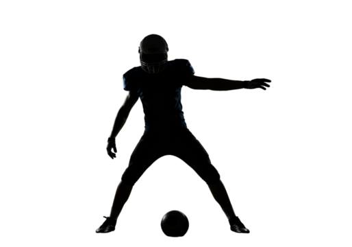 Football Player Silhouette Kicking Ball Isolated On A Black Background