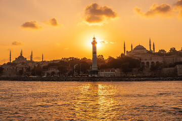 Lighthouse, mosque and hagia sophia at sunset in istanbul, turkey