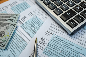 Financial documents and dollar bills for U.S. tax season preparation with 1040 forms