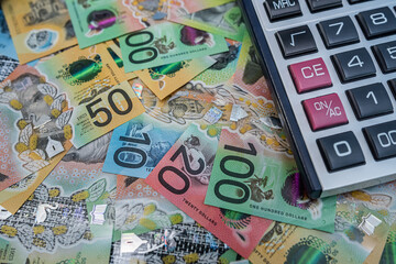 Australian dollar banknotes and calculator for financial planning, budgeting and accounting