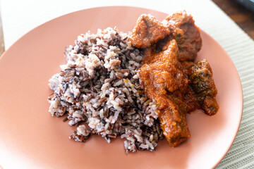 Wild rice served with spicy Nigerian tomato pepper stew