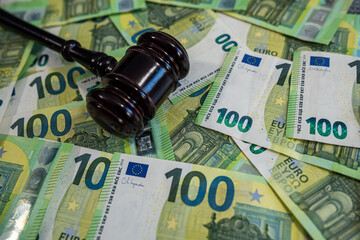 Scattered 100 euro bills representing European currency, financial security, and economic power