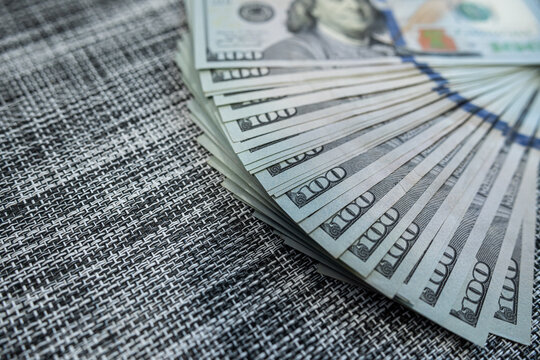 Magnifying glass over dollar bills – Financial audit, money analysis or fraud investigation concept - Powered by Adobe