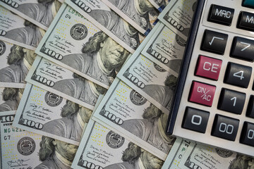 US Dollar Bills and Calculator: Concepts of Financial Management and Economic Progress
