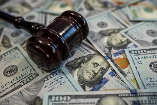Judge's gavel on pile of US dollar bills &ndash; Concept of justice, corruption, bribery or court fines