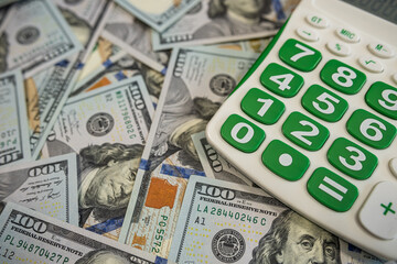Financial Accounting and Business Planning with Calculator on American Hundred Dollar Banknotes