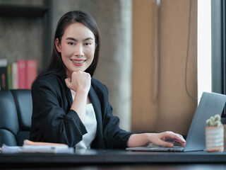 Asian businesswoman working on a laptop computer.