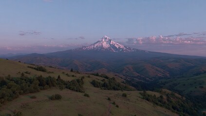 Majestic mountain vista with snow-capped peak at dawn.