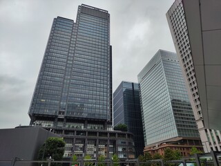 Tall modern buildings in Tokyo bustling urban landscape on a cloudy day