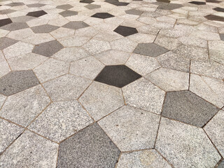 Geometric patterns on urban pavement create a distinctive surface design for walkways and public...