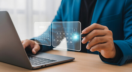 A person in a blue jacket interacts with a virtual calendar on a laptop screen.