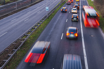 Blurry cars in motion on a busy road during the evening rush hour