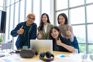 Happy diverse group Asian business start up freelance team analyzing statistics financial. Group...