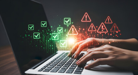 Hands type on a laptop with checkmarks and warning signs displayed on the screen.