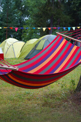 Colorful hammock in the forest with camping background.