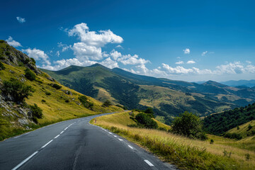Naklejka premium Breathtaking mountain road with green hills and blue sky invites adventure on a sunny day