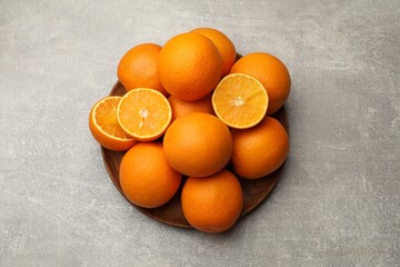 Fresh ripe oranges on grey table, top view