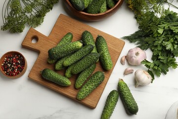 Making pickles. Fresh cucumbers, spices and herbs on white table, flat lay