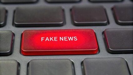 A close-up of a keyboard with a prominent red key labeled "FAKE NEWS" symbolizing misinformation in digital media.