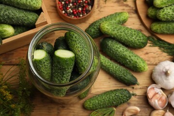 Making pickles. Fresh cucumbers and other ingredients on wooden table, flat lay