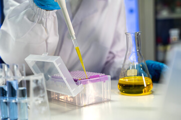 Unknown lab technician working with lab pipette in medical laboratory