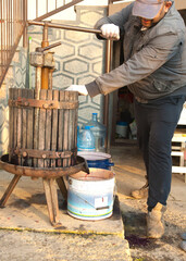 Uzhhorod.Ukraine.10.10.2021. Squeezing grape juice using a hand press for further wine production