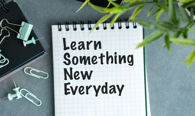 A notebook with the words learn something new everyday written on it