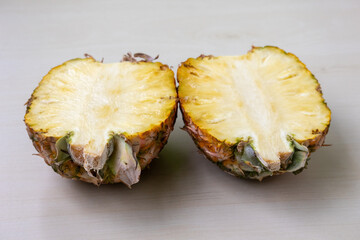 Close-up of a perfectly ripe pineapple, sliced open revealing its juicy interior, sweet Ananas comosus.