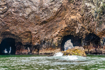 A dramatic view of the rugged coastal cliffs of the Ballestas Islands in Peru
