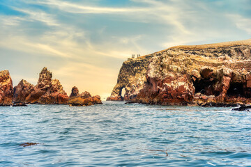 A dramatic view of the rugged coastal cliffs of the Ballestas Islands in Peru