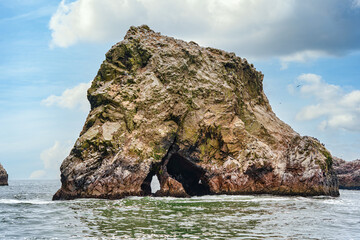 A dramatic view of the rugged coastal cliffs of the Ballestas Islands in Peru