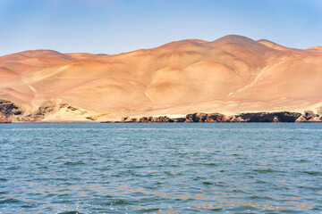 Dramatic landscape with the rocky coastline of the Pacific ocean in Paracas National Reserve.