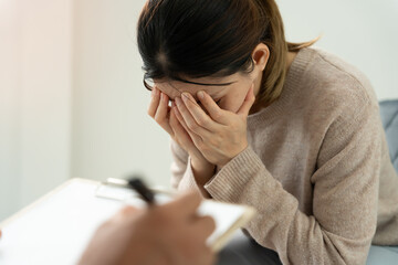 woman with mental health problems is consulting. psychiatrist is recording the patient's condition...