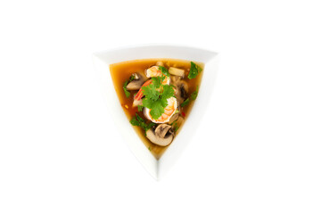 a white bowl filled with soup and vegetables