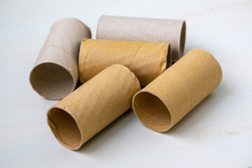 Many empty toilet paper roll cores and cardboard tubes. Out of paper, these paper tubes highlight scarcity and waste, perfect for sustainability themes.