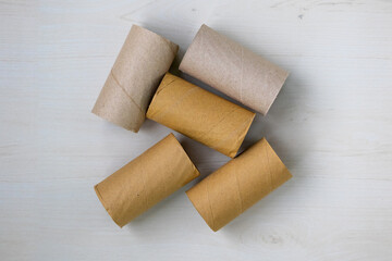 Empty toilet paper roll cores. Discarded paper tubes and cardboard rolls, out of paper. A visual of...