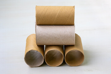 Pile of empty toilet paper roll cores. Discarded paper tubes and cardboard rolls, out of paper. A stark image of scarcity, consumption, or recycling waste.