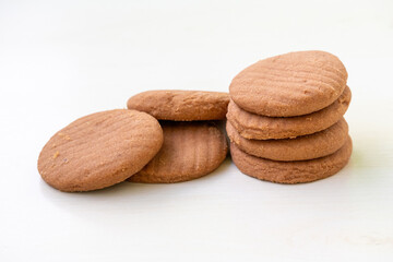 Delicious chocolate flavor biscuits isolated on white. Crispy, tasty round cookies perfect for tea time or any time snack.
