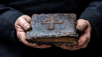 Old leather-bound book held in weathered hands with a cross symbol, representing knowledge and spirituality