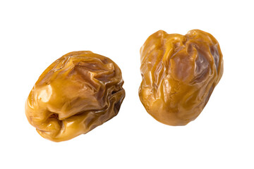 two dried dates on a white surface